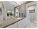 Elegant bathroom boasts sleek countertops, a large mirror, and stylish wallpaper in the adjacent toilet room at 1040 E Osborn Rd # 1103, Phoenix, AZ 85014