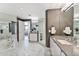 Modern bathroom featuring a luxurious soaking tub, stylish vanities, and a glass-enclosed shower at 1040 E Osborn Rd # 1103, Phoenix, AZ 85014