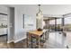 Bright dining room features modern light fixture, sleek table with seating, and balcony access with city views at 1040 E Osborn Rd # 1103, Phoenix, AZ 85014
