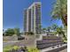 Modern condo building featuring a paved driveway, desert landscaping, and monument sign at 1040 E Osborn Rd # 1103, Phoenix, AZ 85014