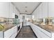 Modern kitchen with sleek white cabinets, granite countertops, and stainless steel appliances at 1040 E Osborn Rd # 1103, Phoenix, AZ 85014