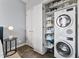 Efficient laundry area with stackable washer/dryer and ample storage space in shelving unit at 1040 E Osborn Rd # 1103, Phoenix, AZ 85014
