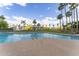 Community pool view with a gazebo, palm trees, and blue skies with decorative clouds at 1040 E Osborn Rd # 1103, Phoenix, AZ 85014