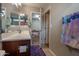 Bathroom with a vanity and a view into the bedroom with a bed at 10850 W Bronco Trl, Peoria, AZ 85383