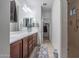 The bathroom features a long vanity with double sinks, a walk-in closet, and a glass-enclosed shower at 10850 W Bronco Trl, Peoria, AZ 85383