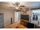 The carpeted bedroom offers an entertainment setup and a door leading to a closet, blending functionality and comfort at 10850 W Bronco Trl, Peoria, AZ 85383
