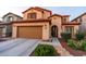 Charming two-story home with a well-maintained lawn, desert landscaping, and a two car garage at 10850 W Bronco Trl, Peoria, AZ 85383