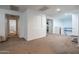 Hallway area featuring neutral carpet, white walls, and several doorways leading to other rooms at 10850 W Bronco Trl, Peoria, AZ 85383