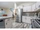 Modern kitchen with stainless steel appliances and a view of the staircase to the second story at 10850 W Bronco Trl, Peoria, AZ 85383