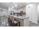 Bright kitchen with granite countertops, stainless steel appliances, and barstool seating at 10850 W Bronco Trl, Peoria, AZ 85383