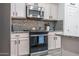 Modern kitchen featuring stainless steel appliances and sleek cabinets at 10850 W Bronco Trl, Peoria, AZ 85383