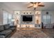 Bright living room features a large built-in entertainment center, modern lighting, and neutral color palette at 10850 W Bronco Trl, Peoria, AZ 85383