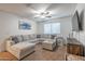Comfortable living room with a sectional sofa, ceiling fan, and modern decor at 10850 W Bronco Trl, Peoria, AZ 85383