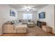 Comfortable living room with a sectional sofa, ceiling fan, and modern decor at 10850 W Bronco Trl, Peoria, AZ 85383