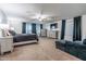 Large primary bedroom with neutral carpet, natural light, and comfortable sitting area at 10850 W Bronco Trl, Peoria, AZ 85383