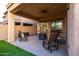 Covered outdoor patio featuring comfortable seating and ceiling fan for relaxation and entertaining at 10850 W Bronco Trl, Peoria, AZ 85383
