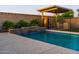Gorgeous swimming pool with stone accents, water feature, patio, and covered barbeque area at 10850 W Bronco Trl, Peoria, AZ 85383