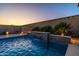 Stunning pool with a stone waterfall feature and lush greenery creating a private outdoor oasis at 10850 W Bronco Trl, Peoria, AZ 85383