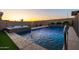 Inviting pool and spa featuring stone accents, water features, and serene ambiance at sunset at 10850 W Bronco Trl, Peoria, AZ 85383
