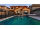 Backyard pool featuring a safety fence, hot tub, and desert landscaping for a relaxing outdoor retreat at 10850 W Bronco Trl, Peoria, AZ 85383