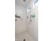 This shower features white tile, a built-in bench, and multiple shower heads for a spa-like experience at 10850 W Bronco Trl, Peoria, AZ 85383