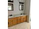 Bathroom featuring double sinks, wood cabinets and granite countertops at 11001 Clear Water --, Goodyear, AZ 85338