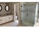 Bright bathroom featuring double sinks with white cabinets and a glass-enclosed shower at 11001 Clear Water --, Goodyear, AZ 85338