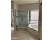 Well lit bathroom with a bathtub and a glass enclosed shower next to a window at 11001 Clear Water --, Goodyear, AZ 85338