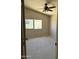 View of a bedroom with neutral colored walls, a ceiling fan, carpet, and a window at 11001 Clear Water --, Goodyear, AZ 85338
