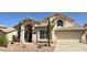 Charming single-Gathering home showcasing desert landscaping, a two-car garage, and beautiful architectural details at 11001 Clear Water --, Goodyear, AZ 85338