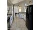Well-lit kitchen with white cabinets, granite countertops, tile flooring, and modern black appliances at 11001 Clear Water --, Goodyear, AZ 85338