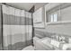 Neat bathroom with white vanity, shower with patterned curtain, and modern fixtures at 1243 E Susan Ln, Tempe, AZ 85288