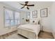 Cozy bedroom features a queen-sized bed with bright natural light at 13811 W Paso Trl, Peoria, AZ 85383