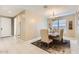 Dining area features a chandelier, natural lighting and neutral decor at 13811 W Paso Trl, Peoria, AZ 85383