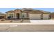 Inviting single-story home featuring a three car garage and low maintenance desert landscaping at 13811 W Paso Trl, Peoria, AZ 85383