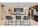 Modern kitchen boasts granite countertops, stainless steel appliances, and an island with bar seating at 13811 W Paso Trl, Peoria, AZ 85383