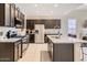 Beautiful kitchen featuring granite countertops, a stainless fridge and a center island at 13811 W Paso Trl, Peoria, AZ 85383