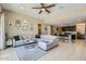 Spacious living room open to the kitchen, featuring tile floors and neutral paint at 13811 W Paso Trl, Peoria, AZ 85383