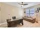 Inviting office space featuring a wooden desk, neutral tones, and a comfortable couch with natural light at 13811 W Paso Trl, Peoria, AZ 85383