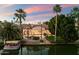 Breathtaking aerial view of a waterfront estate with a pool, lush landscaping, and a private dock at 1507 E Treasure Cove Dr, Gilbert, AZ 85234