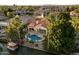Waterfront home featuring a private pool, mature trees, and lush landscaping at 1507 E Treasure Cove Dr, Gilbert, AZ 85234