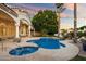 Resort-style backyard with a sparkling pool, lush landscaping, and a spacious patio, ideal for outdoor entertaining at 1507 E Treasure Cove Dr, Gilbert, AZ 85234