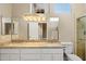 Bathroom with dual sinks, granite countertops and tiled shower at 1507 E Treasure Cove Dr, Gilbert, AZ 85234