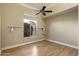 Sunlit bedroom featuring hardwood floors and view of landscaping at 1507 E Treasure Cove Dr, Gilbert, AZ 85234