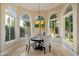 Cozy breakfast nook with round table and chairs surrounded by large windows at 1507 E Treasure Cove Dr, Gilbert, AZ 85234