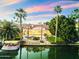 Waterfront home with pool, boat dock, lush landscaping, and gorgeous sunset views at 1507 E Treasure Cove Dr, Gilbert, AZ 85234
