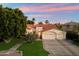 Charming home with a three-car garage, tile roof, and beautifully landscaped front yard at 1507 E Treasure Cove Dr, Gilbert, AZ 85234