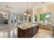 Bright, open kitchen with tile floors, stainless appliances, and a large island at 1507 E Treasure Cove Dr, Gilbert, AZ 85234
