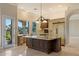 Well-equipped kitchen with stainless appliances, tile floors, and a large island at 1507 E Treasure Cove Dr, Gilbert, AZ 85234