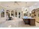 Bright, open kitchen with tile floors, stainless appliances, and a large kitchen island at 1507 E Treasure Cove Dr, Gilbert, AZ 85234